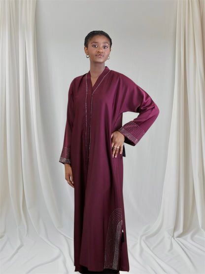 Woman wearing a burgundy long-sleeve dress 