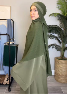 Woman wearing an olive green Essential Dubai Abaya — modest fashion for women by Ayesha's Collection USA