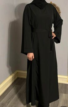 Woman wearing a classic black Essential Dubai Abaya — everyday modest fashion by Ayesha's Collection