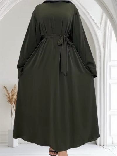 Woman wearing a dark green Essential Dubai Abaya — modest everyday wear by Ayesha's Collection USA