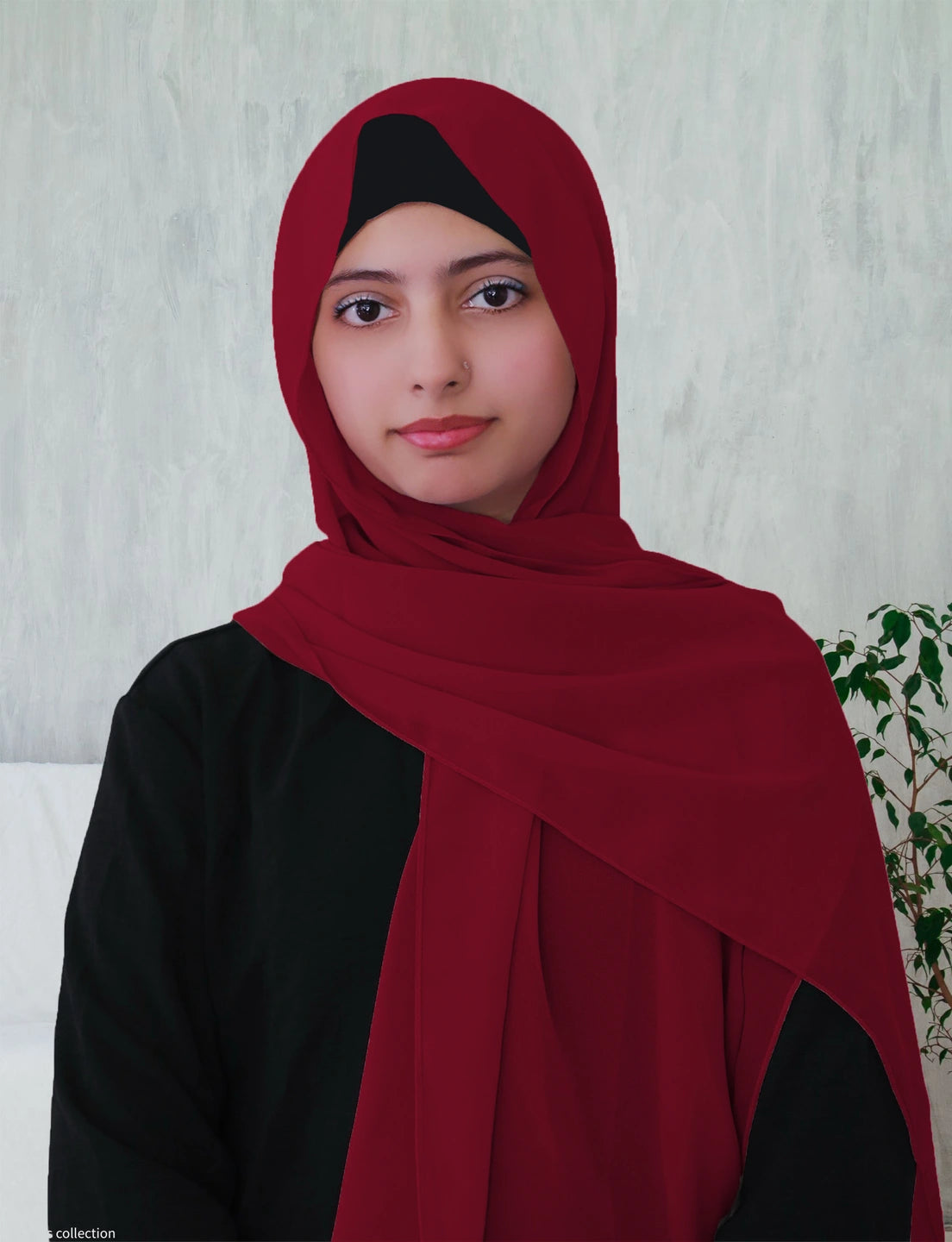 A women wearing a magenta chiffon hijab.
