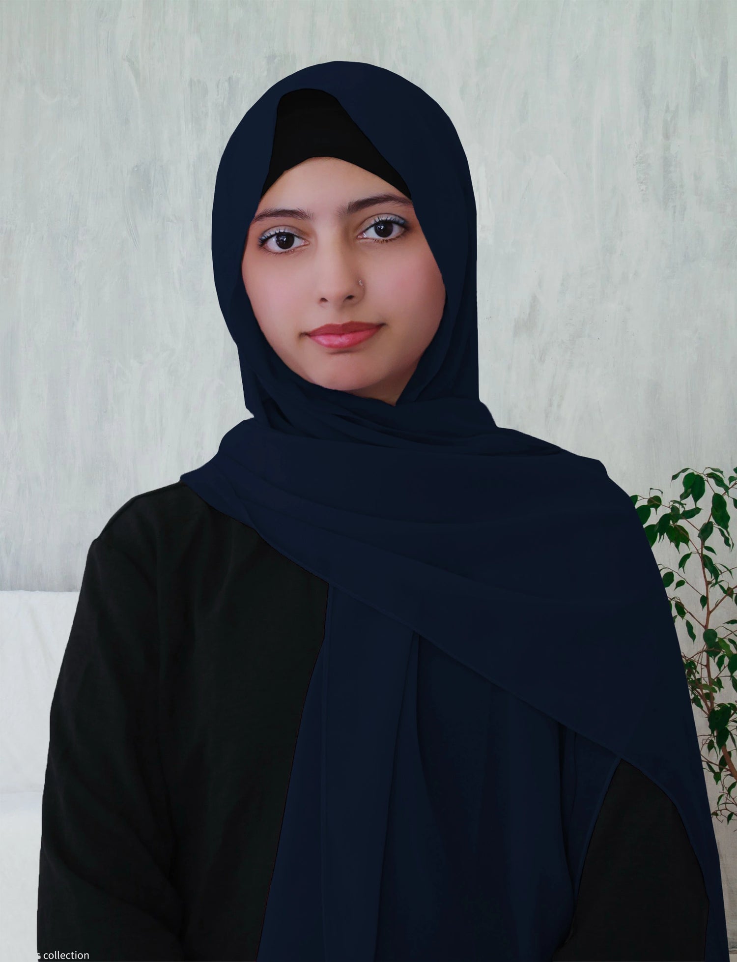 A woman wearing a blue chiffon hijab with a long rectangle shape.