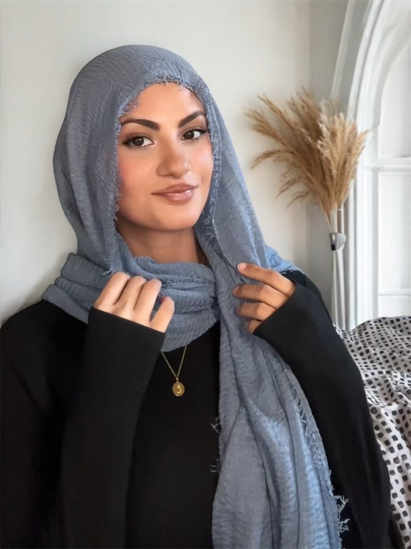 Woman wearing a light blue hijab