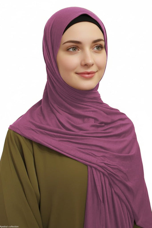 Woman wearing a purple hijab on a white background