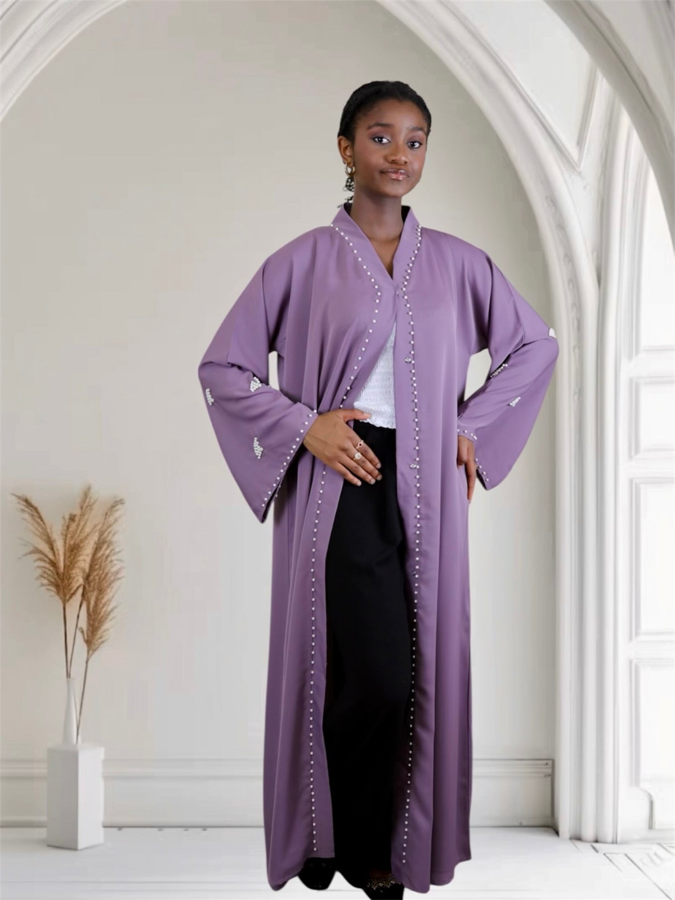 Woman wearing a long purple dress with white embellishments