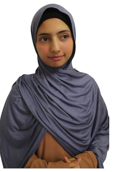 A woman wearing a dusty blue cotton jersey hijab.