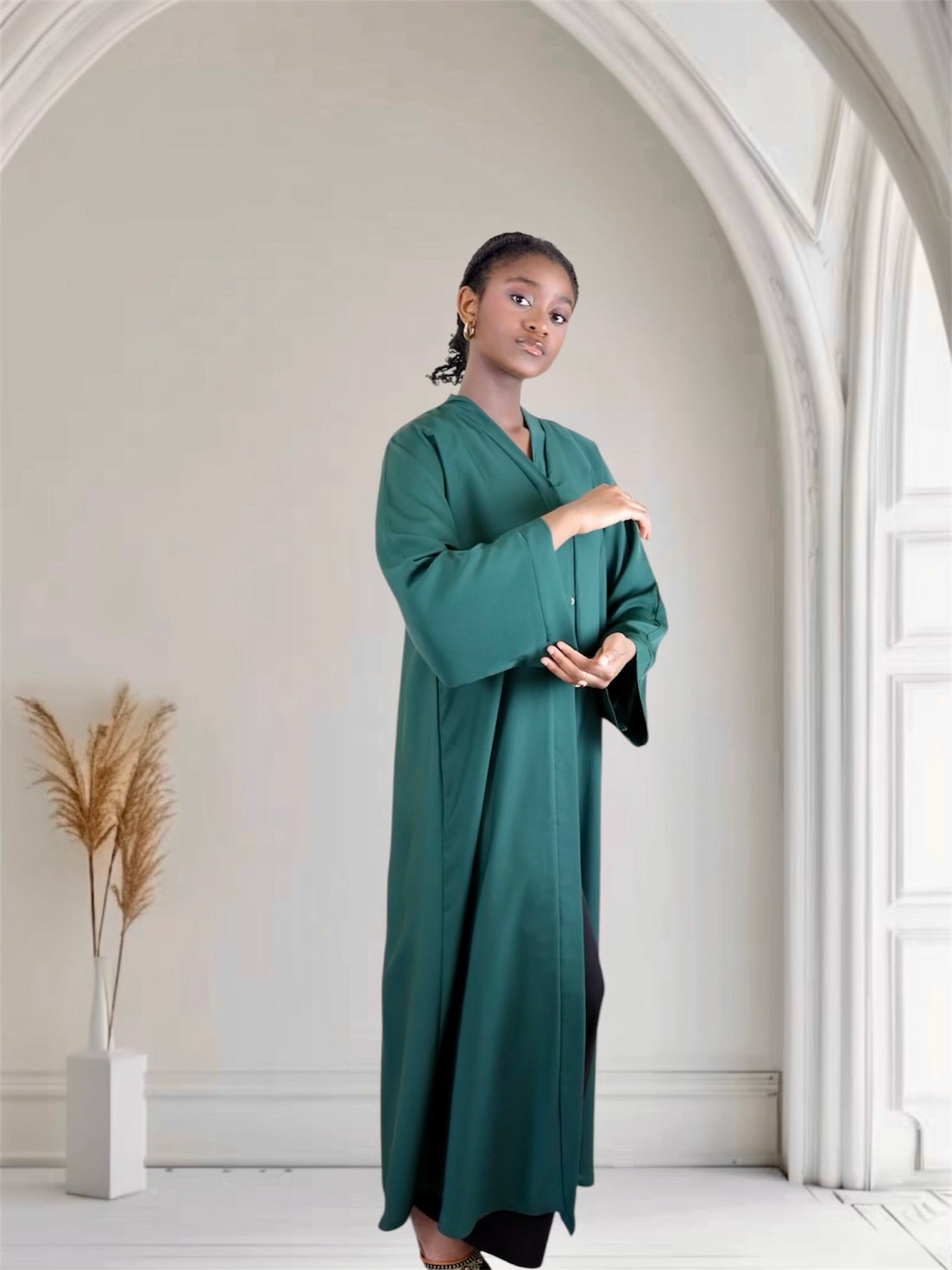 Woman in a long green abaya dress 