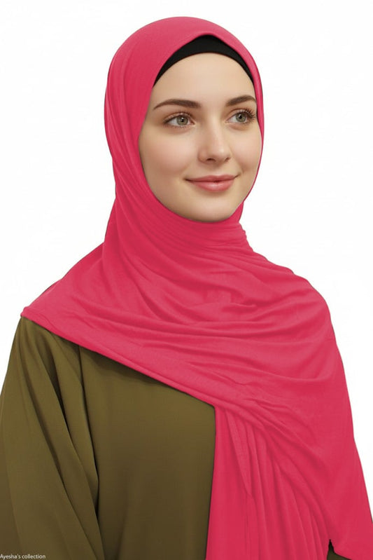 Woman wearing a bright pink hijab on a white background