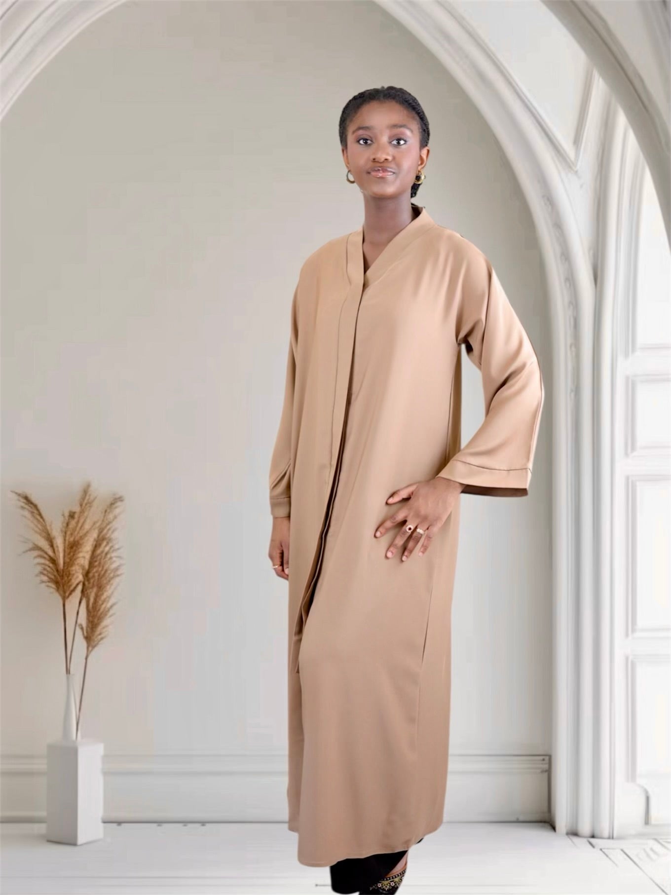 Woman wearing a light brown long abaya dress