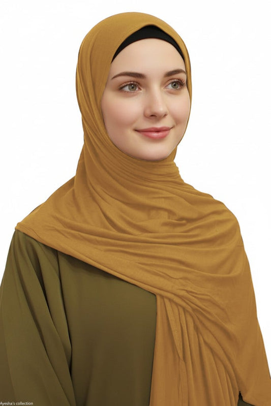 Woman wearing a light brown hijab.
