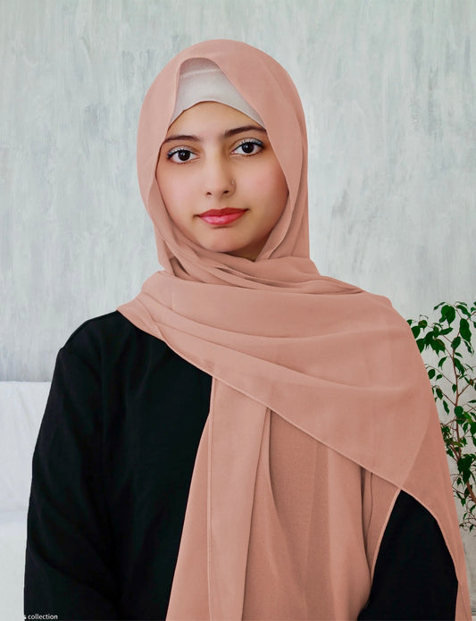 A woman wearing a light peach chiffon scarf