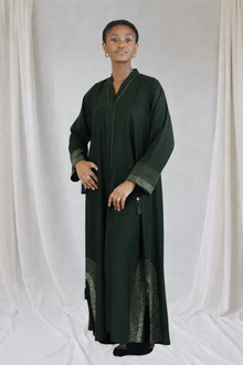 women wearing a dark green abaya with rhinestones embellishment