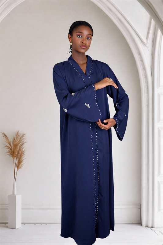 Woman wearing a navy blue dress with white embellishment