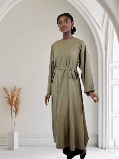Woman long-sleeve, knee-length abaya dress with a belt