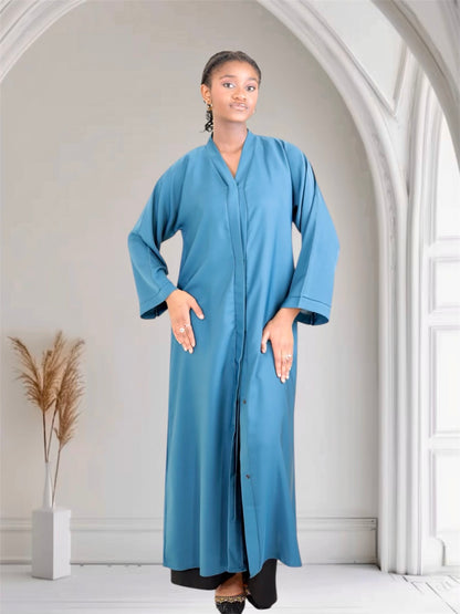 Woman wearing a long blue abaya dress