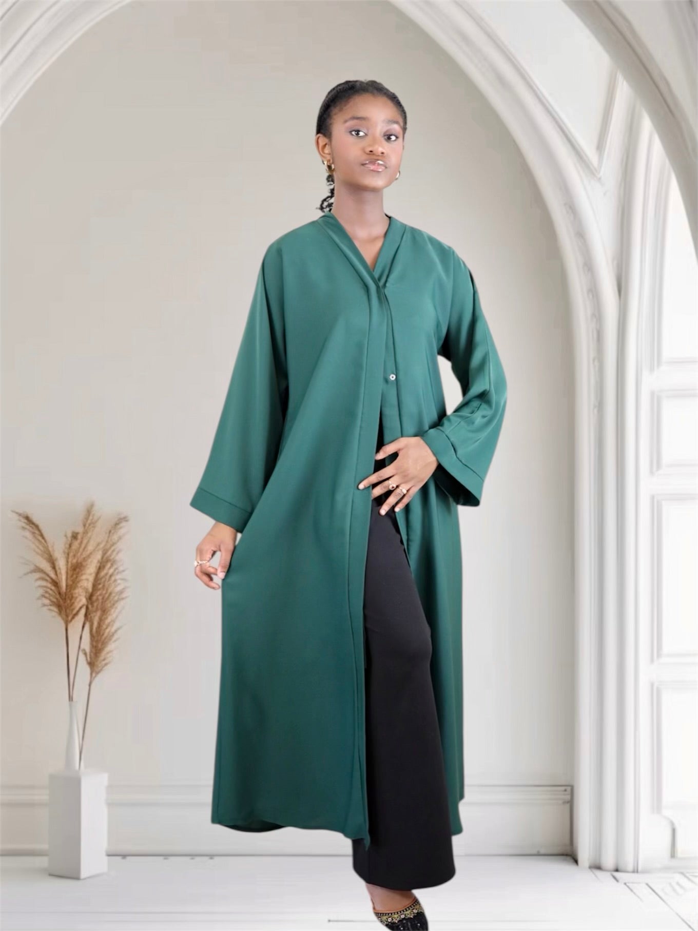 Woman wearing a long dark green abaya dress